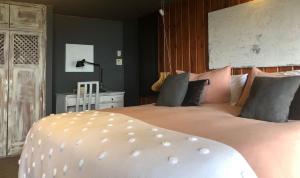 a bedroom with a large white bed with pink pillows at Meular Room One in Castro