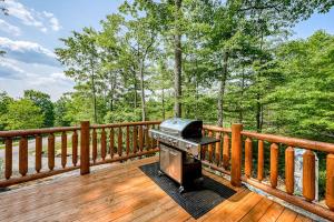 a grill on a wooden deck with trees in the background at Deep Creek Mountain Retreat in McHenry