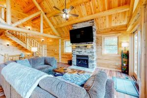 a living room with a couch and a fireplace at Deep Creek Mountain Retreat in McHenry