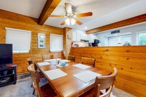 a dining room with a table and a ceiling fan at Hibernation Hideaway in McHenry
