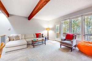 a living room with a couch and a table at Hibernation Hideaway in McHenry