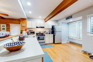 a kitchen with white cabinets and a bowl on a counter at Hibernation Hideaway in McHenry