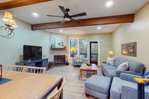 a living room with a couch and a ceiling fan at Liftside Retreat in McHenry