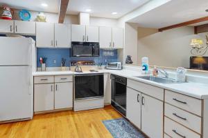 a kitchen with white cabinets and a white refrigerator at Liftside Retreat in McHenry