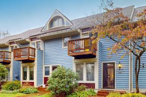 a blue house with two balconies on it at Liftside Retreat in McHenry