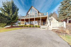 a large house with a porch and a driveway at Bear's Eye View in McHenry