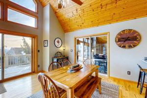 a dining room with a wooden table and a clock at Bear's Eye View in McHenry
