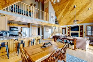 a kitchen and dining room with a wooden table and chairs at Bear's Eye View in McHenry