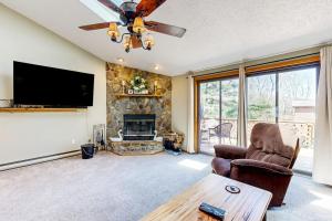 a living room with a fireplace and a flat screen tv at Oakland Oasis in Oakland