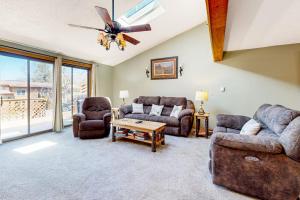 a living room with couches and a ceiling fan at Oakland Oasis in Oakland