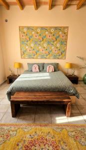 a bedroom with a bed and a painting on the wall at Amore in Chianti in Greve in Chianti