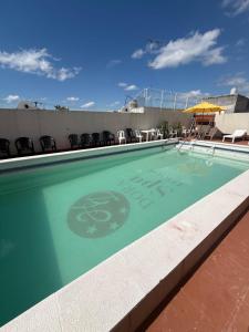 a swimming pool on top of a building at Hotel Dora in Termas de Río Hondo