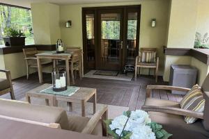 a living room with a couch and chairs and a table at The Frank Lloyd Wright Home @ Deep Creek, MD in Bittinger