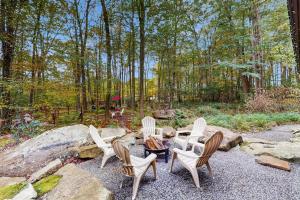 a group of chairs and a table in the woods at The Frank Lloyd Wright Home @ Deep Creek, MD in Bittinger