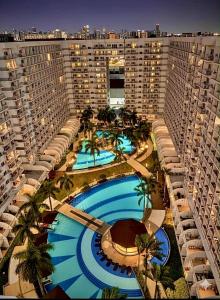 an aerial view of a large building with two large pools at Shell Residence Pasay City in Manila