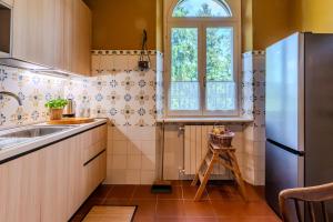 a kitchen with a sink and a refrigerator at Villa dei Ricordi - Apartments near Como, Milan and Malpensa in Mozzate