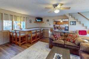 a living room with a couch and a bar at Life's A Bear in McHenry