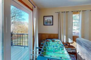 a room with a large glass table with a balcony at Life's A Bear in McHenry