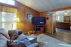 a living room with a couch and a flat screen tv at Life's A Bear in McHenry +18 photos