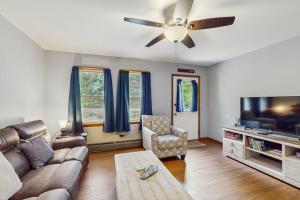 a living room with a couch and a flat screen tv at All Spruced Up in Oakland