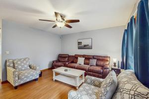 a living room with a couch and a ceiling fan at All Spruced Up in Oakland