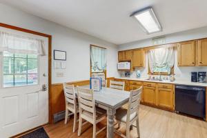 a kitchen with a table and chairs and a door at All Spruced Up in Oakland