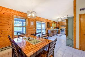 a kitchen and dining room with a wooden table and chairs at Gleanings Pond in McHenry