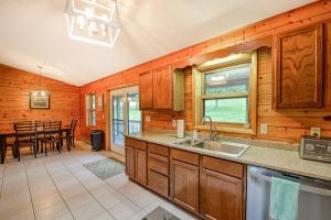 a kitchen with a sink and a dining room at Gleanings Pond in McHenry