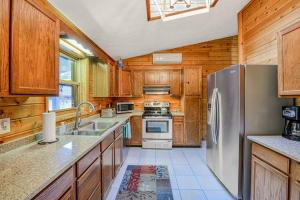 a kitchen with wooden cabinets and a stainless steel refrigerator at Gleanings Pond in McHenry +25 photos