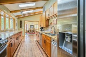 a large kitchen with wooden cabinets and stainless steel appliances at A Million Dollar View in Oakland +39 photos
