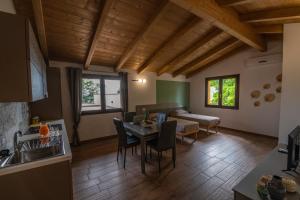 a kitchen and living room with a table and a couch at Il Moro in Tolentino