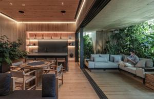 a woman sitting on a couch in a living room at University Tower by Kukun Apartments in Mexico City