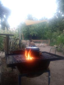 a grill with pots and pans on top of it at Hostal Rústico Las Pircas in Alcoguaz