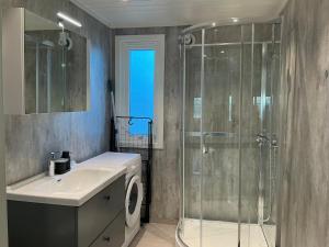 a bathroom with a shower and a sink and a toilet at Cozy Home in Sortland in Sortland +31 photos