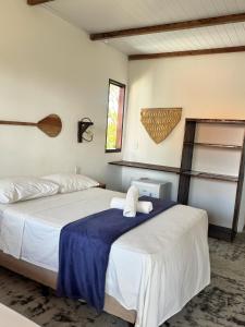 a bedroom with two beds and a window at Maré de Atins Eco Lodge in Atins