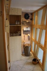 a bathroom with a sink and a basket in a room at Gites des Dix Vins in Dangolsheim