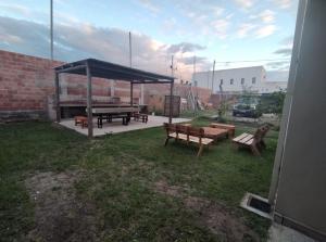 a picnic shelter with benches and a picnic table at Sol Pampa in Concordia