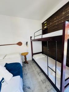 a room with two bunk beds and a table at Maré de Atins Eco Lodge in Atins