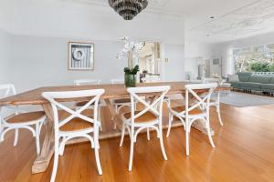 a dining room with a wooden table and chairs at Kirinaran Manor Pool & Bar Room in Frankston South