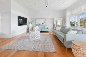 a living room with a couch and a table at Kirinaran Manor Pool & Bar Room in Frankston South