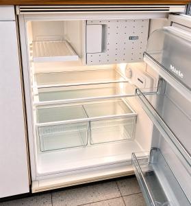 an empty refrigerator with its door open at Fribourg Home in Fribourg