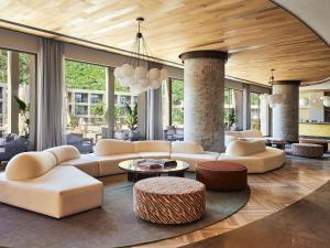 a living room with couches and tables and windows at Hyde Bodrum - Ultra All Inclusive, Adult Only in Torba