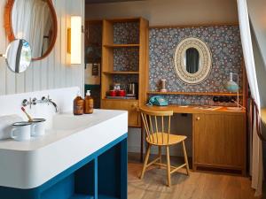 a bathroom with a sink and a mirror at 25hours Hotel Paper Island in Copenhagen +50 photos