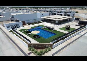 a rendering of a building with a swimming pool at Casa moderna, 3 recámaras, alberca, La Paz BCS in La Paz