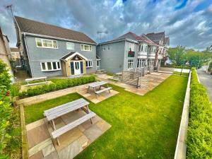 a backyard with a picnic table and a bench at Coastal Park Accommodation in Llanelli