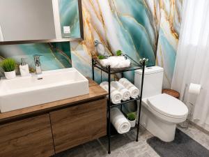 a bathroom with a sink and a toilet at Azure Glow Studio in Brossard