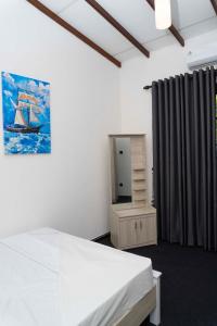 a bedroom with a bed and a dresser and a mirror at Hidden Heaven Grove-Kandy in Kandy