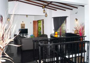 a living room with a couch and a table at Hidden Heaven Grove-Kandy in Kandy