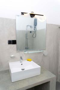 a bathroom with a white sink and a mirror at Hidden Heaven Grove-Kandy in Kandy +20 photos