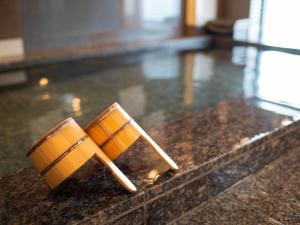 two wooden chopsticks sitting on top of a counter at Super Hotel Totsuka Eki Higashiguchi in Yokohama +34 photos